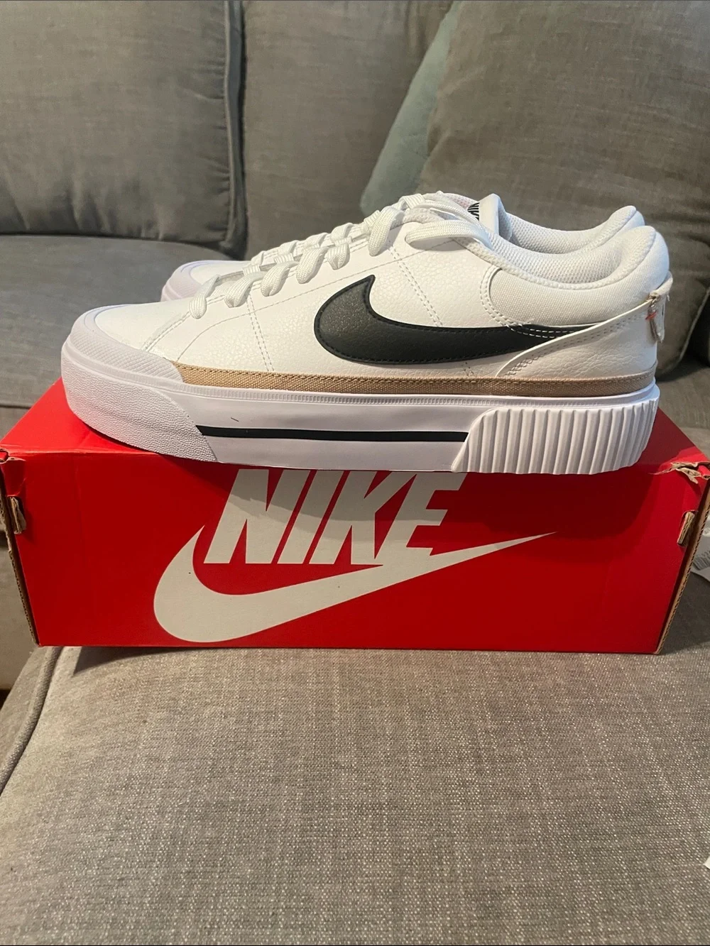 Nike womens White Low-Top Sneakers with Black Swoosh and Tan Accent - Picture 1 of 4